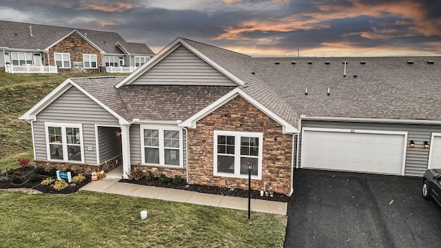 view of front of property with a yard and a garage