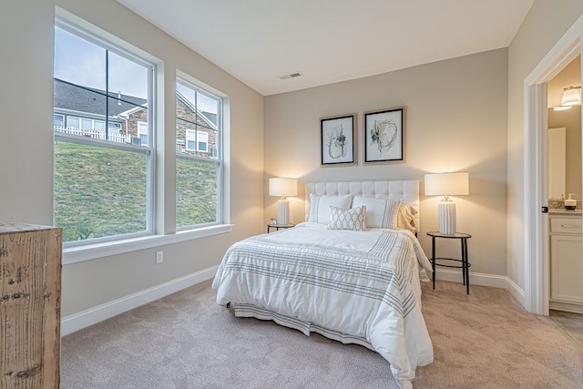 carpeted bedroom featuring connected bathroom