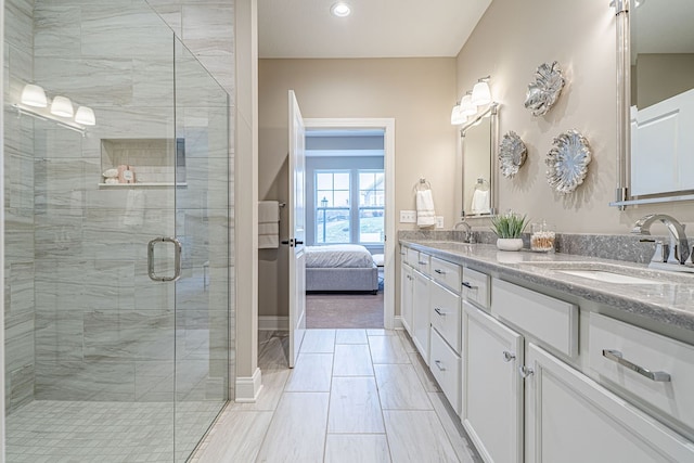 bathroom with vanity and an enclosed shower