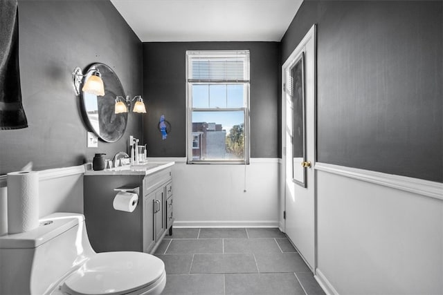 bathroom featuring tile patterned flooring, vanity, and toilet