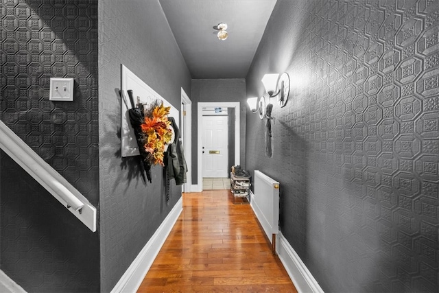 hallway featuring light hardwood / wood-style flooring and radiator