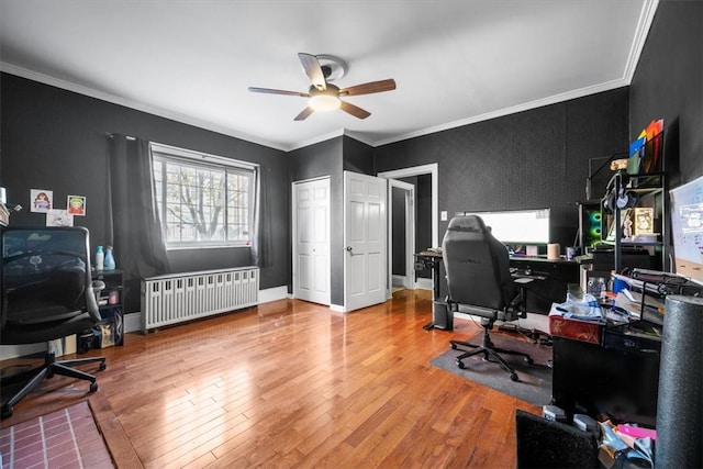 office area with radiator, ceiling fan, crown molding, and wood-type flooring