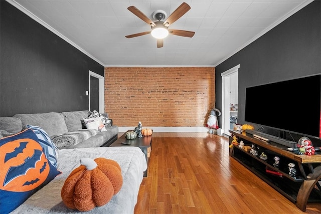 living room featuring ceiling fan, ornamental molding, brick wall, and light hardwood / wood-style flooring