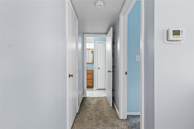 hallway featuring light colored carpet