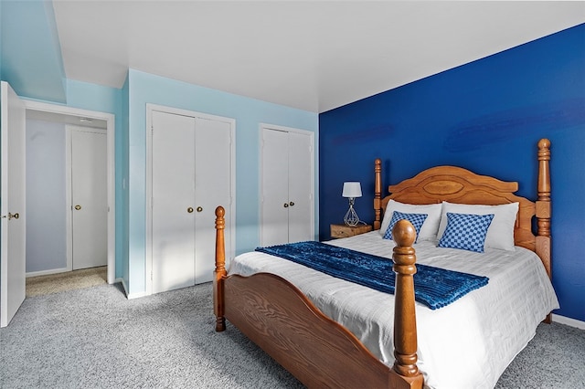 carpeted bedroom featuring two closets