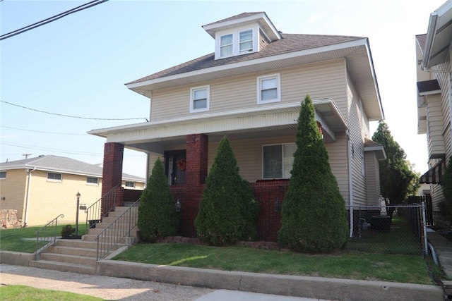 view of front of property with a front yard and a porch