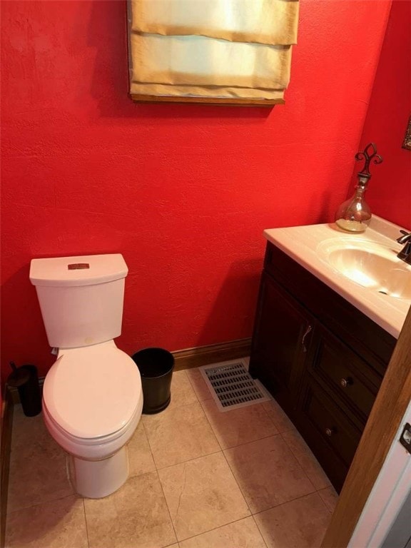 bathroom featuring tile patterned flooring, vanity, and toilet