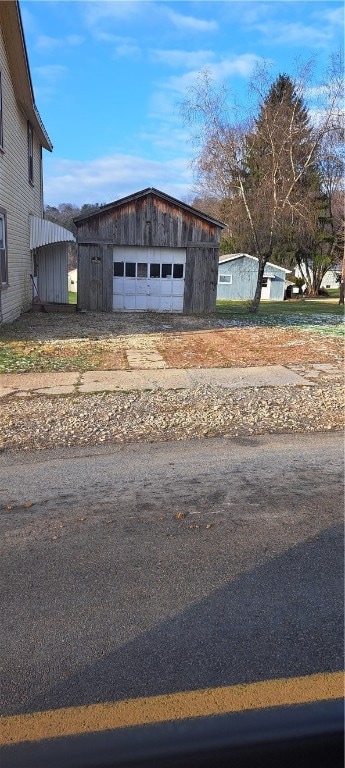 exterior space featuring an outbuilding and a garage