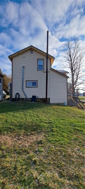 view of side of home featuring a yard