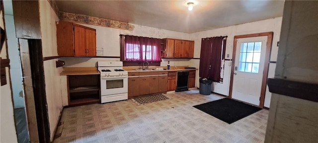 kitchen featuring plenty of natural light, black dishwasher, sink, and white range with gas cooktop