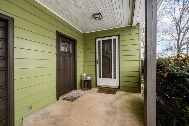 view of exterior entry with covered porch