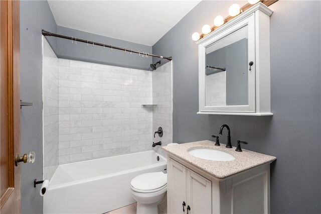 full bathroom with vanity, toilet, and tiled shower / bath