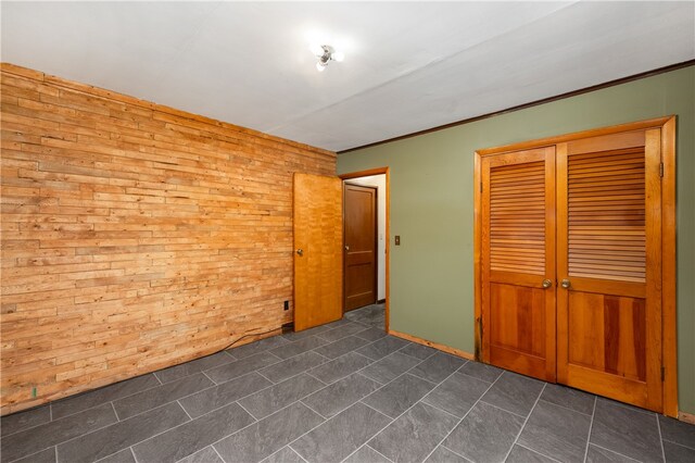 unfurnished room featuring wood walls