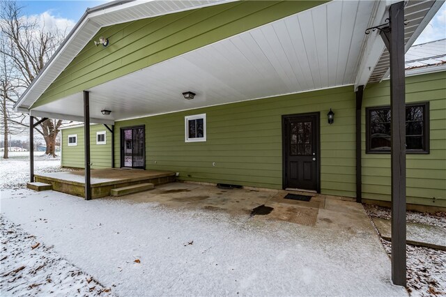 view of snow covered property entrance