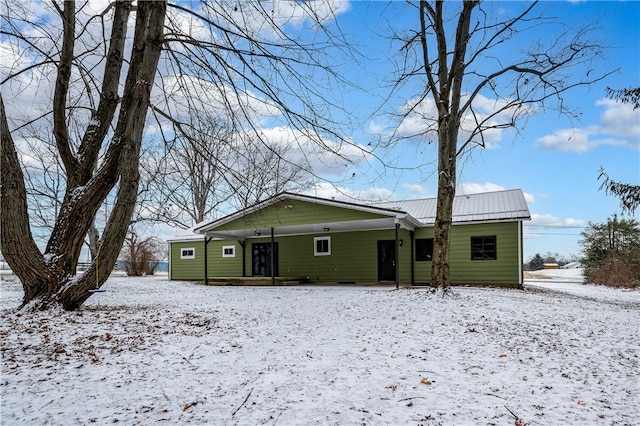 view of snow covered rear of property