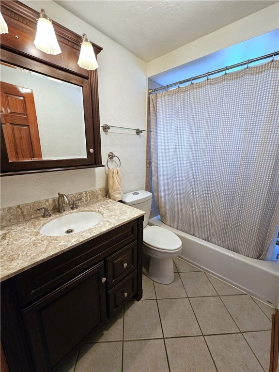 full bathroom with tile patterned floors, vanity, toilet, and shower / bath combo