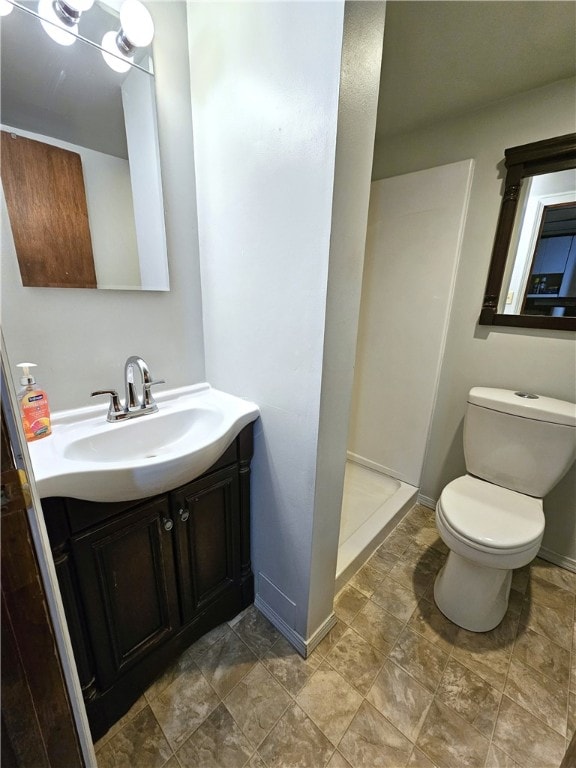 bathroom with vanity, toilet, and walk in shower