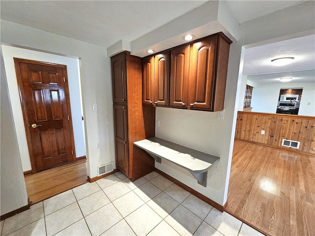 interior space with a textured ceiling and light hardwood / wood-style floors