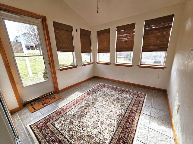 unfurnished sunroom with a wealth of natural light and lofted ceiling