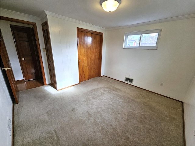 unfurnished bedroom with carpet floors and ornamental molding