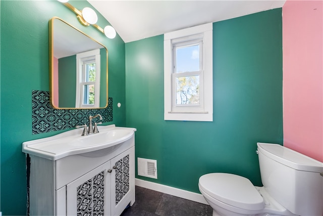 bathroom featuring vanity and toilet