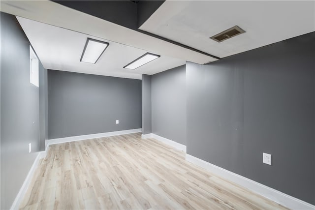 basement with light hardwood / wood-style floors