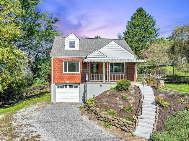 view of front of home featuring covered porch and a garage