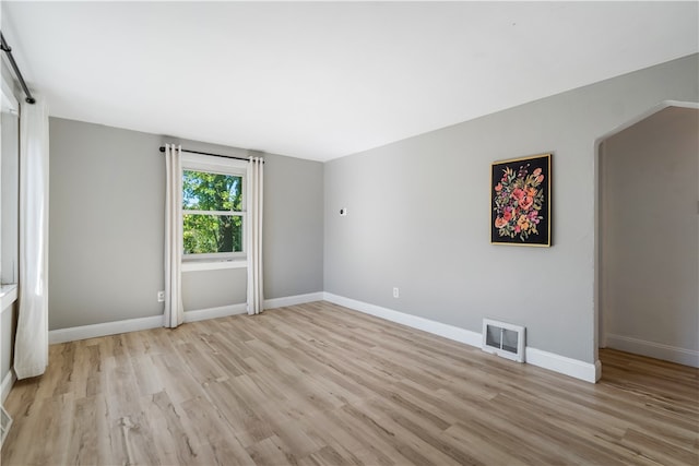 spare room featuring light wood-type flooring