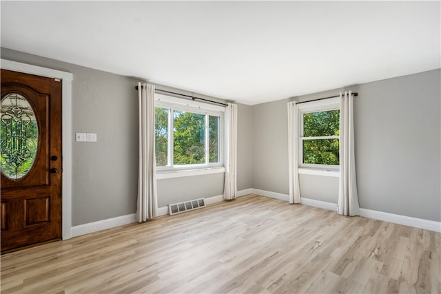 entrance foyer with plenty of natural light and light hardwood / wood-style floors