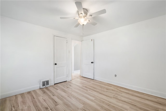 spare room with ceiling fan and light wood-type flooring