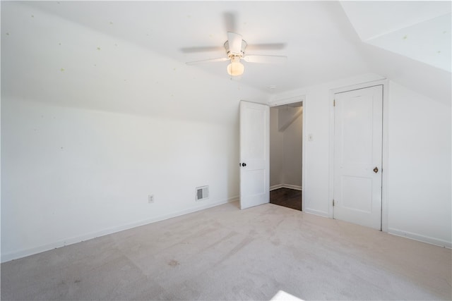 additional living space featuring ceiling fan, light colored carpet, and lofted ceiling