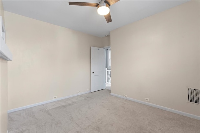 empty room with ceiling fan and light colored carpet