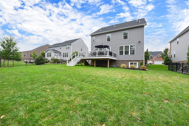 rear view of property with a deck and a lawn