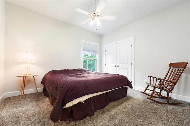 carpeted bedroom with ceiling fan and a closet