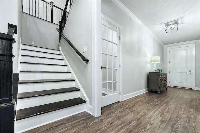 staircase with hardwood / wood-style floors and ornamental molding