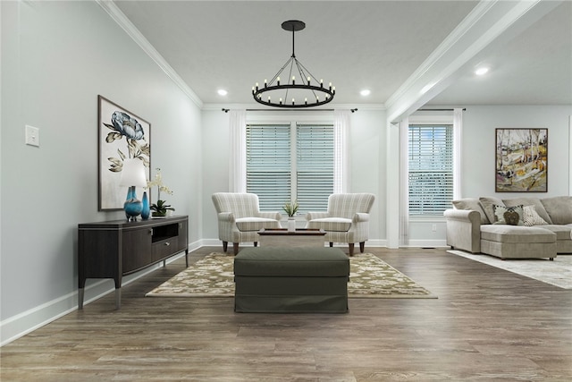 sitting room featuring a chandelier, dark hardwood / wood-style floors, and crown molding