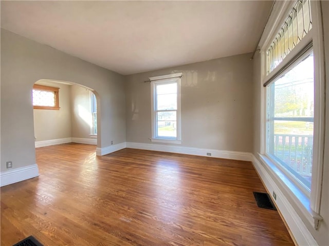 unfurnished room with hardwood / wood-style floors