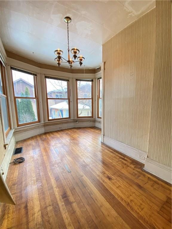 interior space featuring hardwood / wood-style flooring and an inviting chandelier