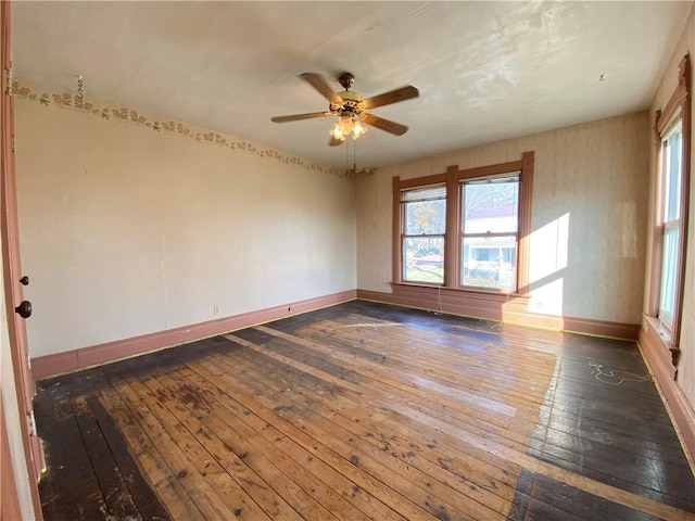 spare room with dark hardwood / wood-style floors and ceiling fan