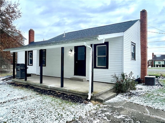 view of front of home featuring covered porch and central air condition unit