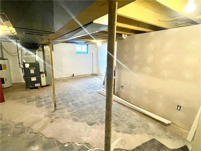 basement featuring heating unit and water heater