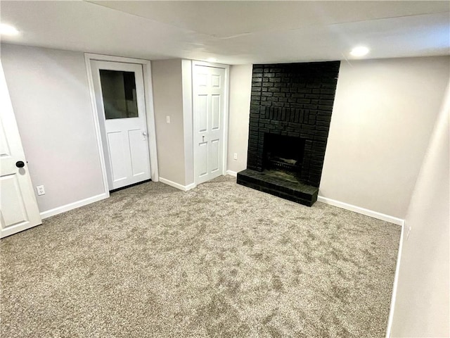 basement featuring carpet flooring and a fireplace