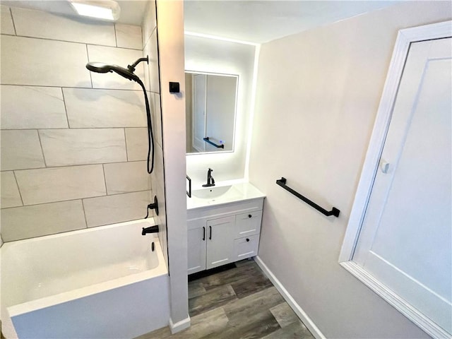 bathroom featuring vanity, wood-type flooring, and tiled shower / bath combo