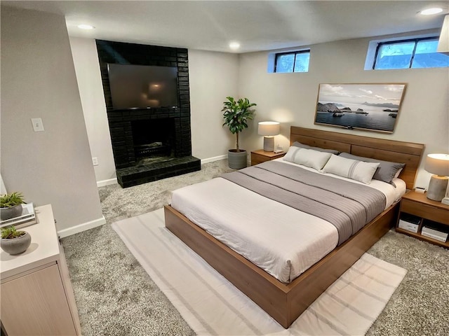 carpeted bedroom featuring a fireplace