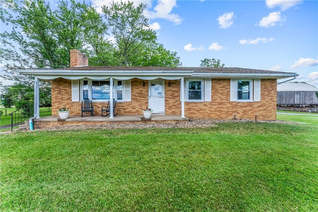 ranch-style house with a porch and a front yard