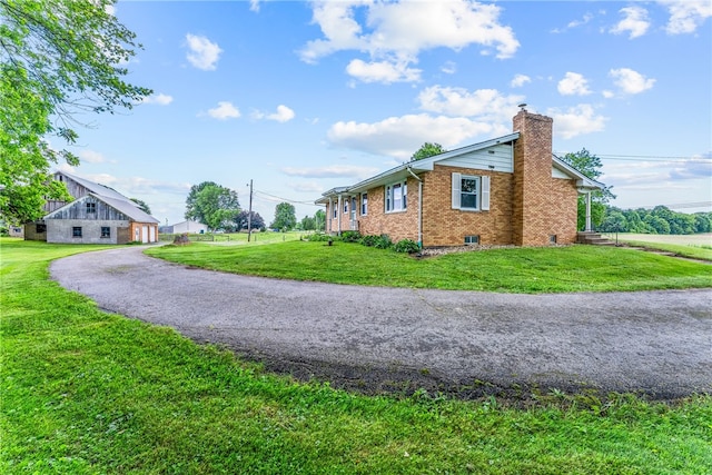 view of side of home featuring a yard