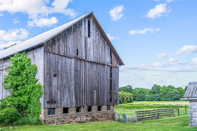 view of outbuilding featuring a lawn