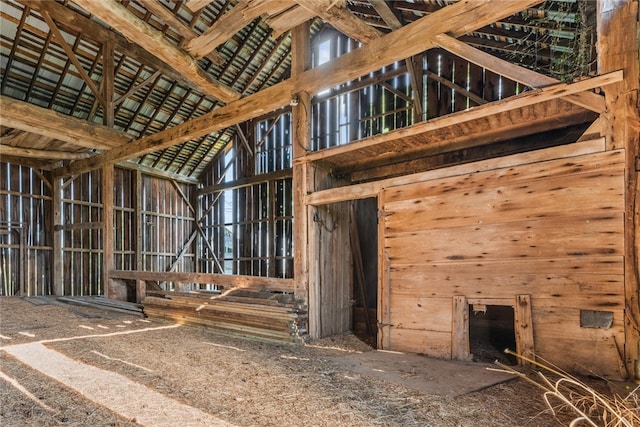 miscellaneous room with wood walls and high vaulted ceiling