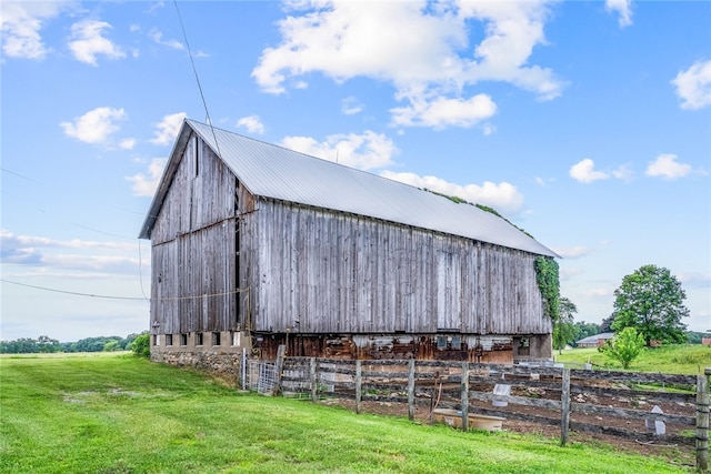 view of outdoor structure featuring a yard and a rural view