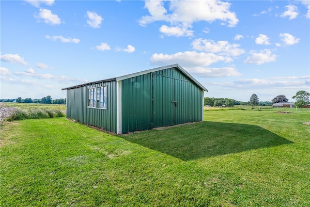 view of outdoor structure featuring a yard and a rural view